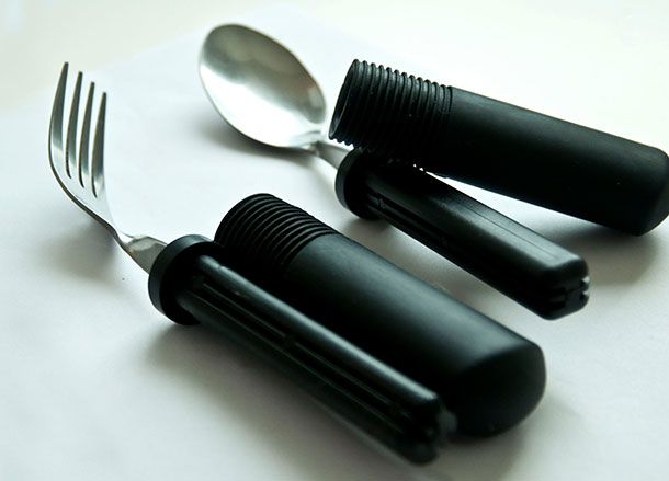 A fork and spoon with wide black modifiable handles