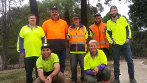 Group of seven people wearing high vis standing outdoors