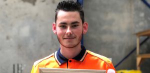 Young man in high vis polo smiling