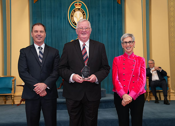 Les Chitts being presented with an award inside Parliament House